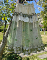 Women's green floral ruffle long skirt with A-line silhouette.