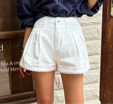 Women's lace trim high waist denim shorts with a loose fit.