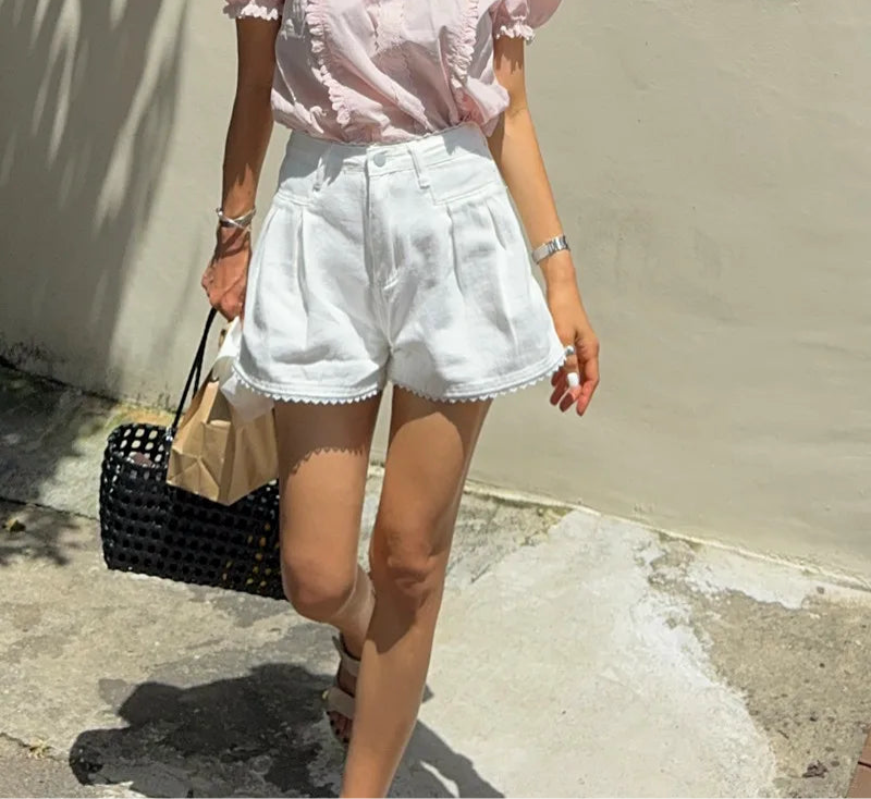 Women's lace trim high waist denim shorts with a loose fit.