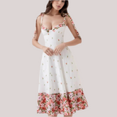 Women's white printed patchwork tie-up maxi dress with floral pattern and V-neck.
