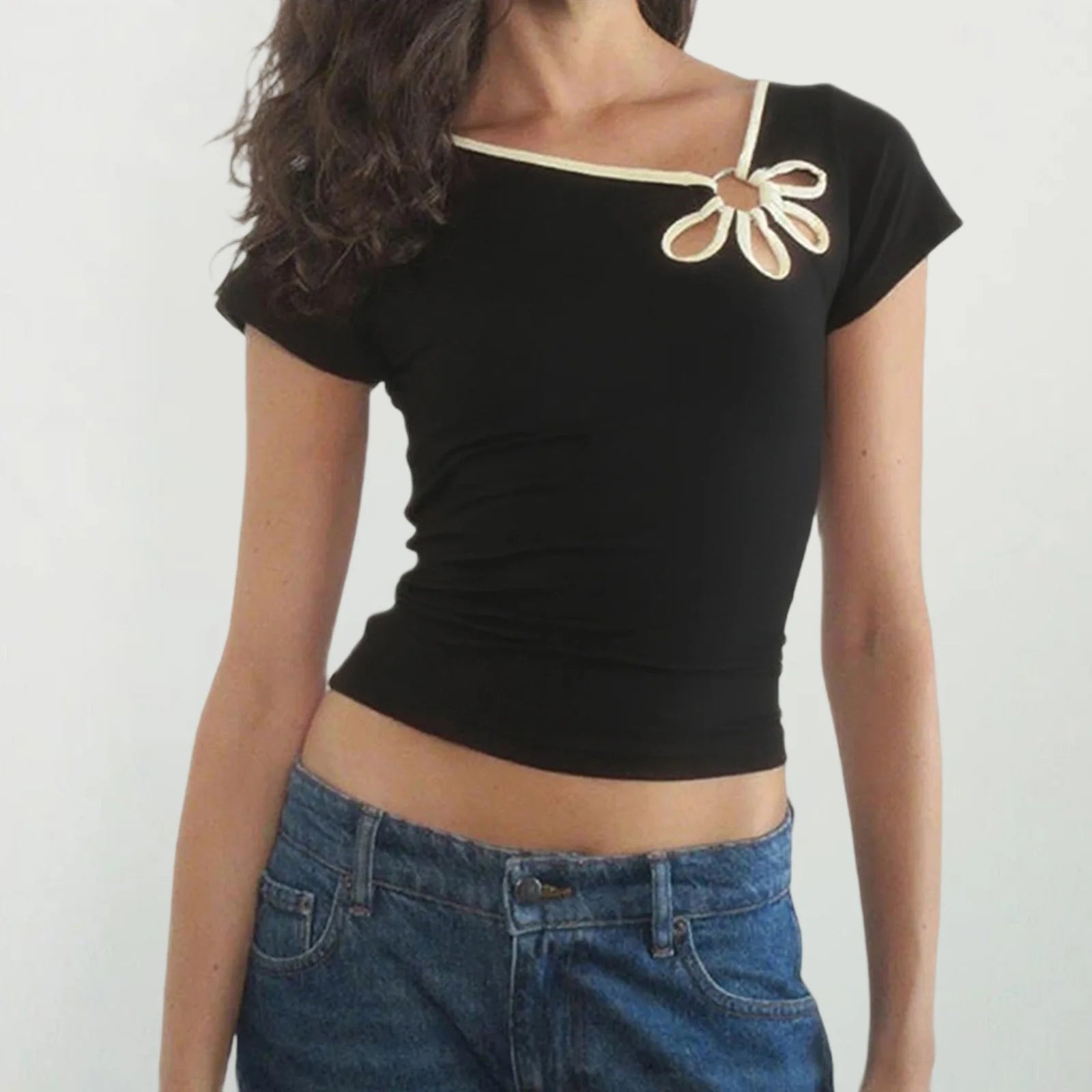 Black crop top with decorative bow detail worn by a model