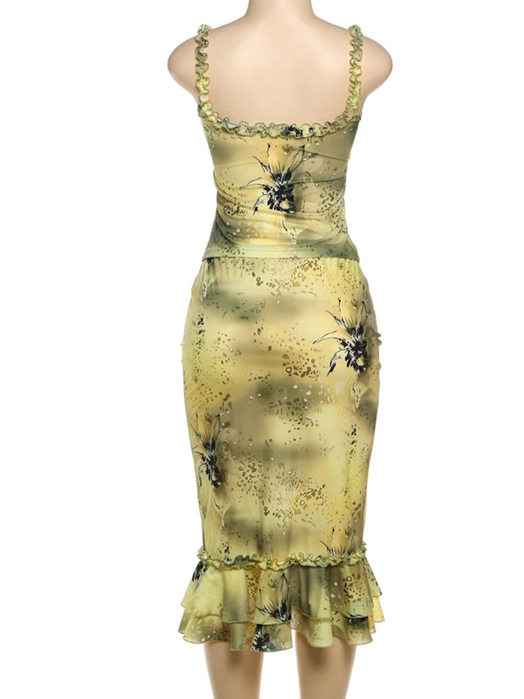 Yellow dress with black floral pattern on a white background