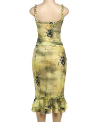 Yellow dress with black floral pattern on a white background