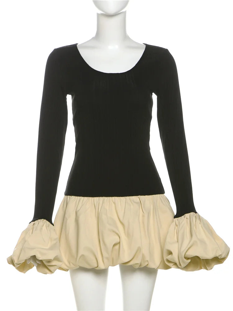 Mannequin wearing a black long-sleeve top with a beige skirt on a white background
