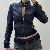 Black leather jacket with gold zippers and buttons worn by a person on a plain background