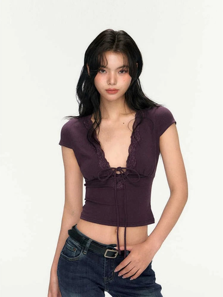 Woman wearing a purple top with lace details