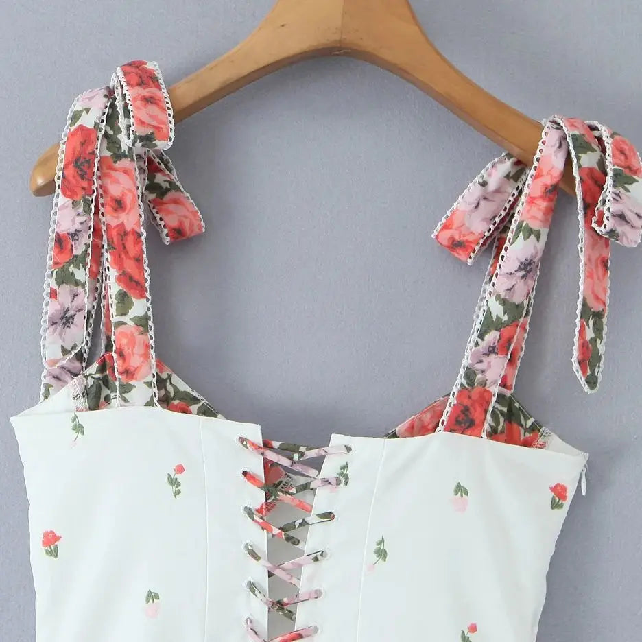 Women's white printed patchwork tie-up maxi dress with floral pattern and V-neck.