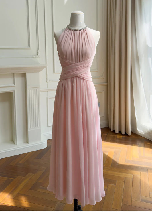 Front view of a pink maxi dress with a high neckline and ruched waist, adorned with a rhinestone chain detail at the neck.