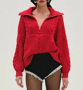 Person wearing a red knitted sweater with a white background