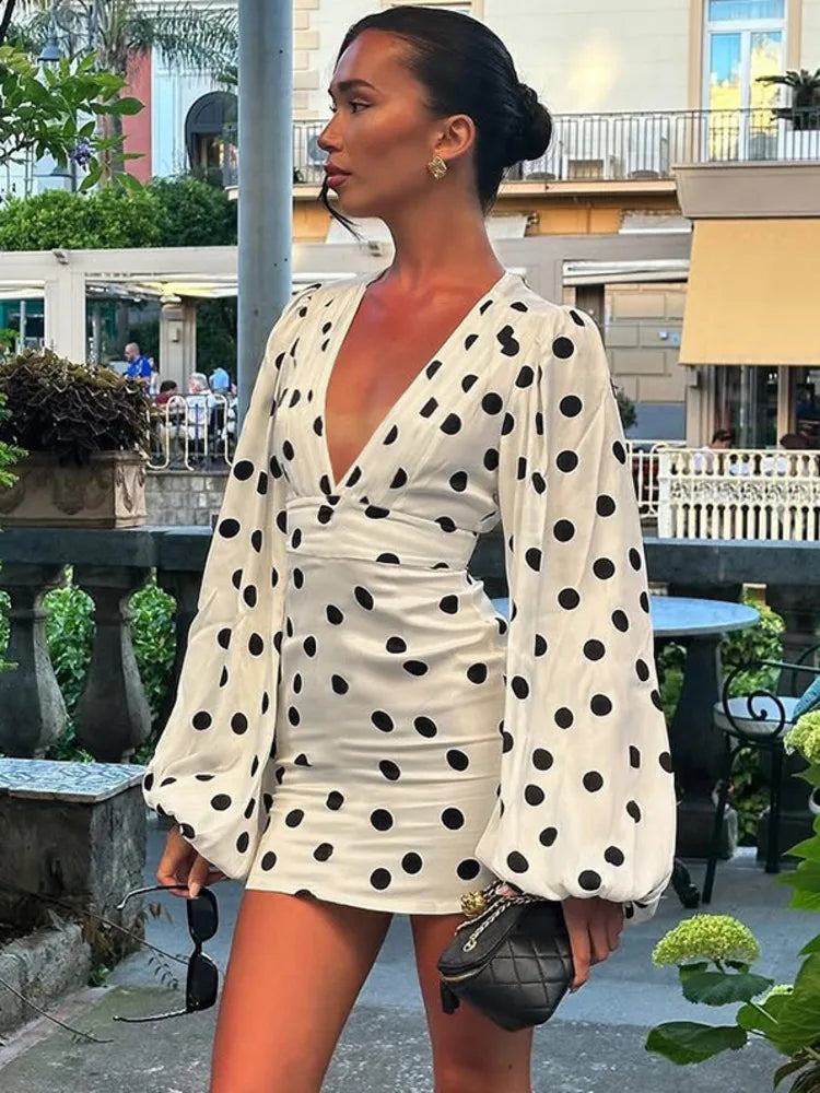 Woman wearing a polka dot dress with long sleeves in an outdoor setting