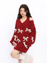 Woman wearing a red sweater with white bow details on a white background