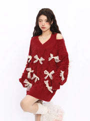Woman wearing a red sweater with white bow details on a white background