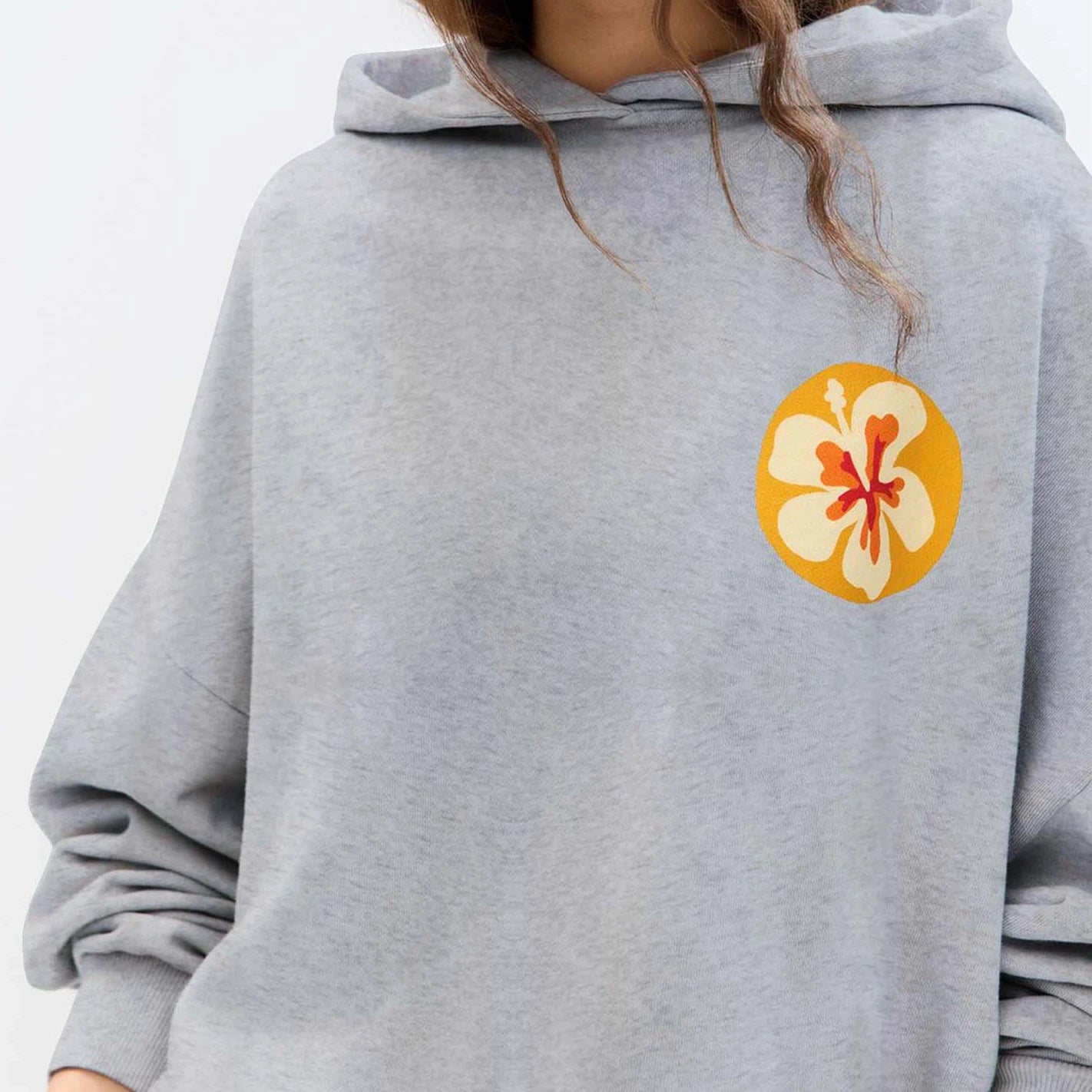 Gray hoodie with a floral patch on the chest-close-up