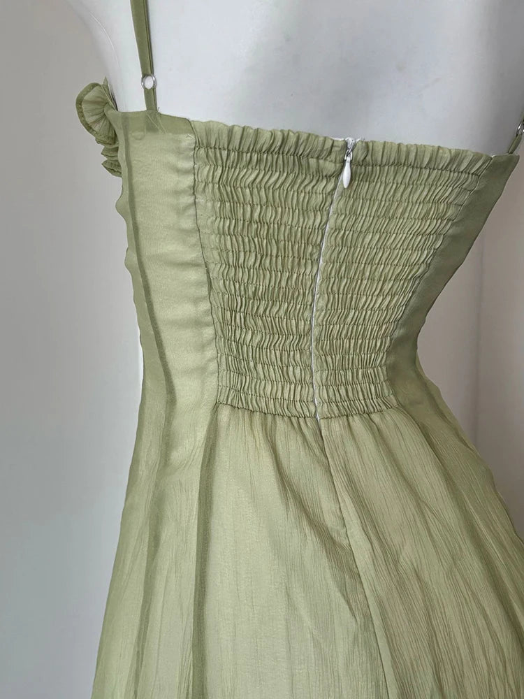 Green dress on a mannequin against a white background