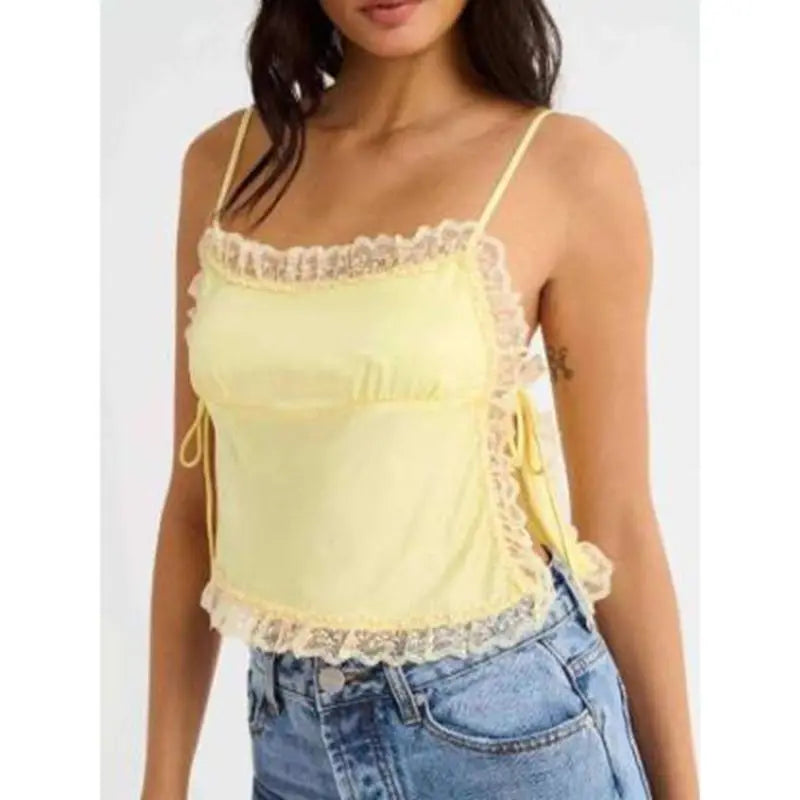 Model displaying a short lace trim satin cami top with an open back.