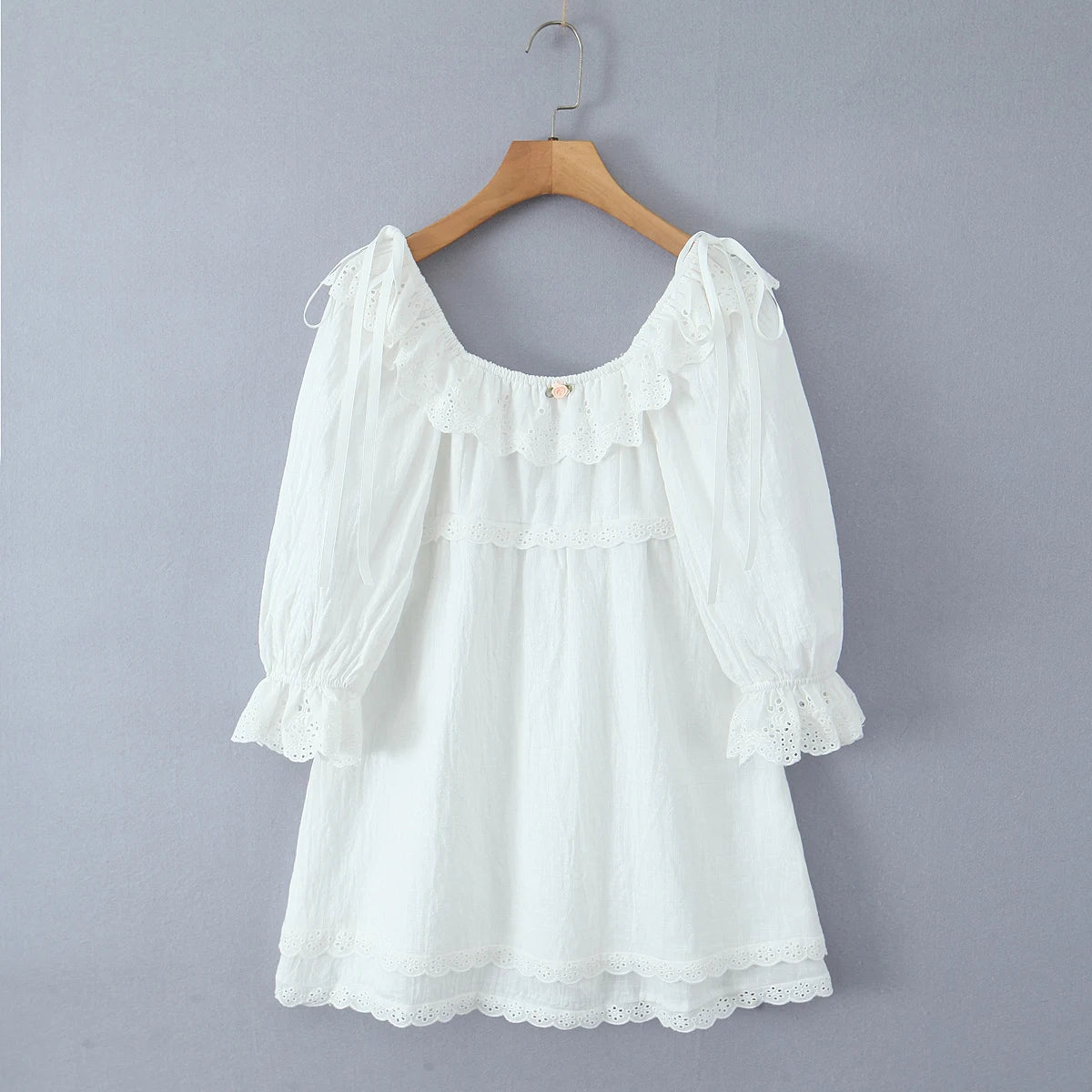 White blouse with ruffled sleeves on a wooden hanger - 3/4 puff sleeves