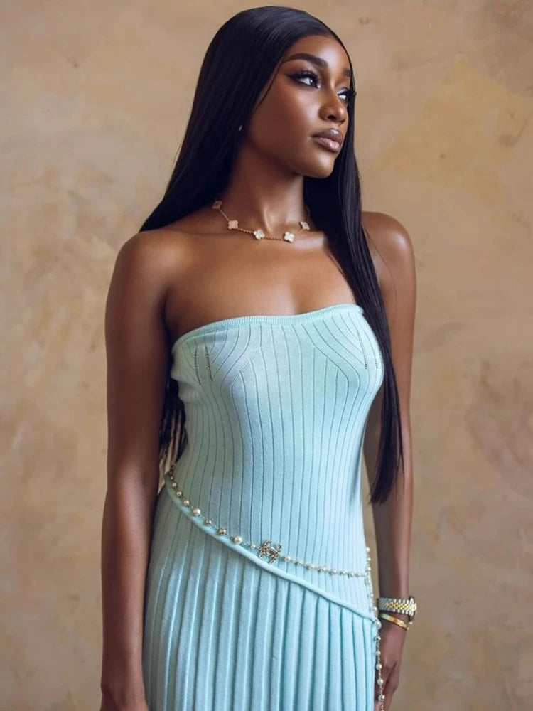 Woman wearing a light blue strapless dress with a beige background