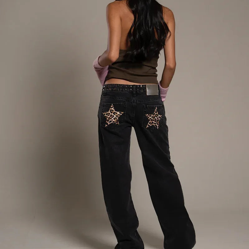 Person wearing black jeans with star designs