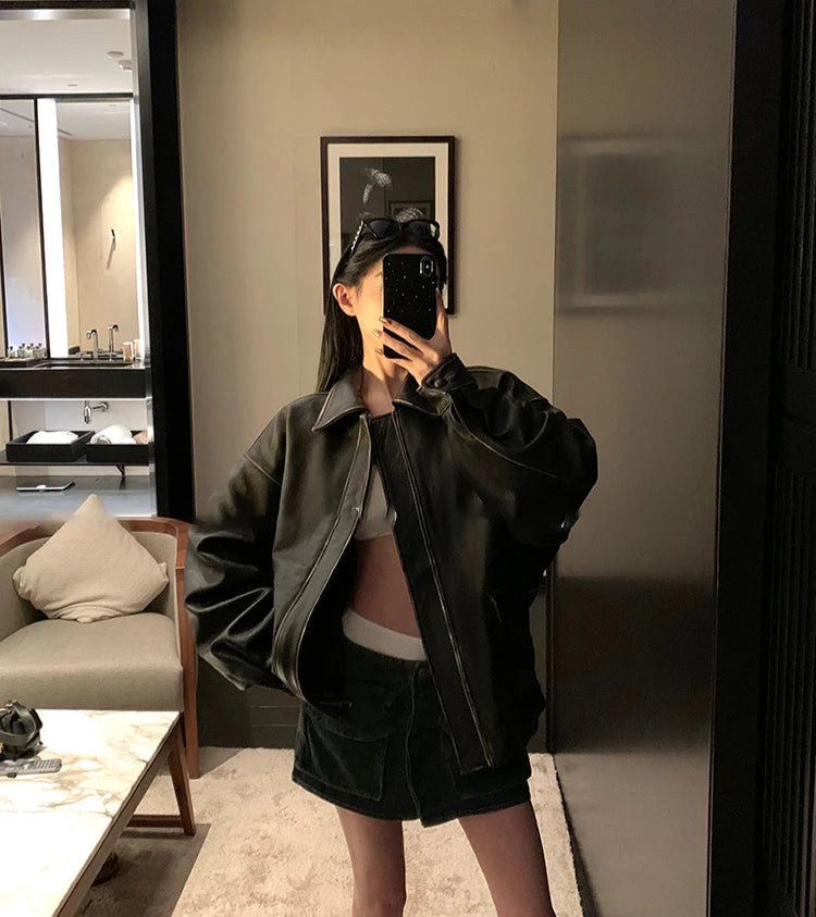 Person taking a mirror selfie in a modern living room.