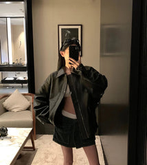 Person taking a mirror selfie in a modern living room.