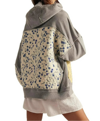 Gray hoodie with floral pattern on the back worn by a person