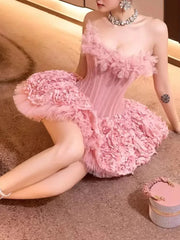 Woman wearing a pink floral dress sitting on a textured surface.