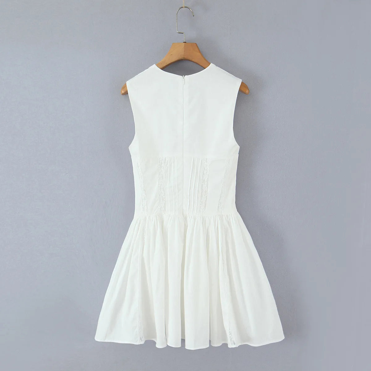 White dress on a hanger against a gray background