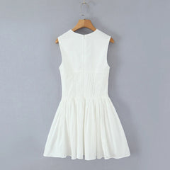 White dress on a hanger against a gray background
