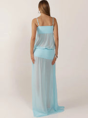 Woman wearing a light blue dress against a plain background