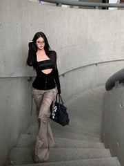 Women's black long sleeve cut out drape halter top with asymmetrical collar.