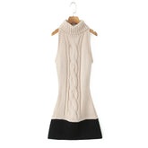 Beige sleeveless knitted dress with black hem on a wooden hanger against a white background