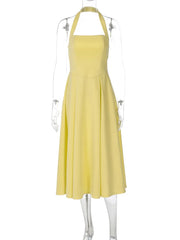 Yellow dress on a mannequin against a white background