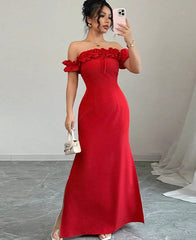 Woman in a red off-shoulder dress taking a mirror selfie.