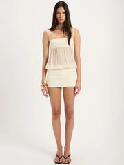 Woman wearing a layered cream dress