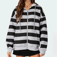 Black and gray striped hoodie worn by a person on a light blue background