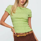 Women's smocked short sleeve top with V-neck and bow detail.