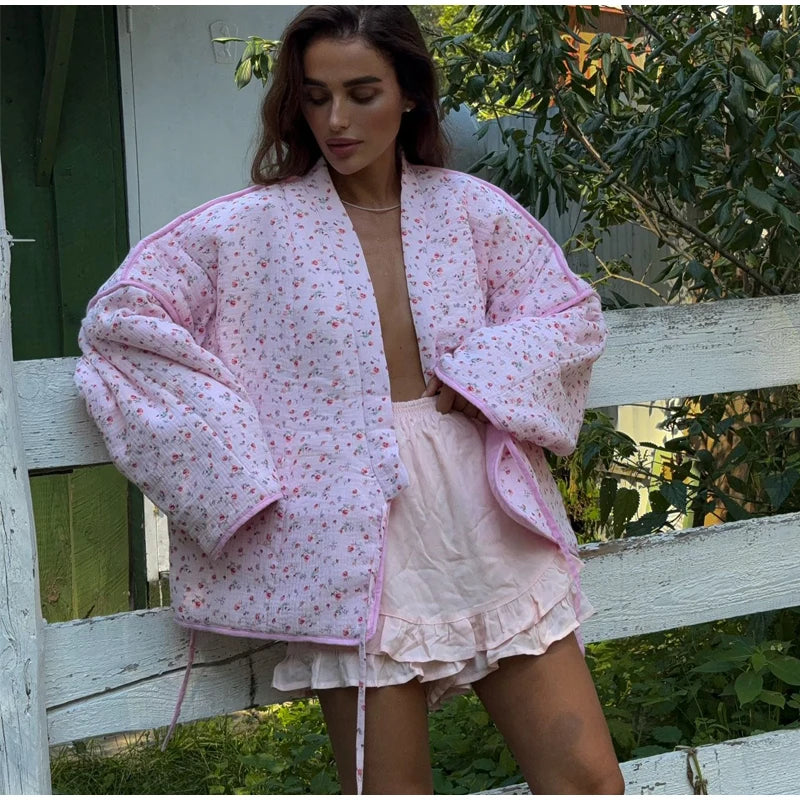 Women's pink printed knit cardigan with covered buttons for autumn and winter.