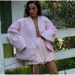 Women's pink printed knit cardigan with covered buttons for autumn and winter.