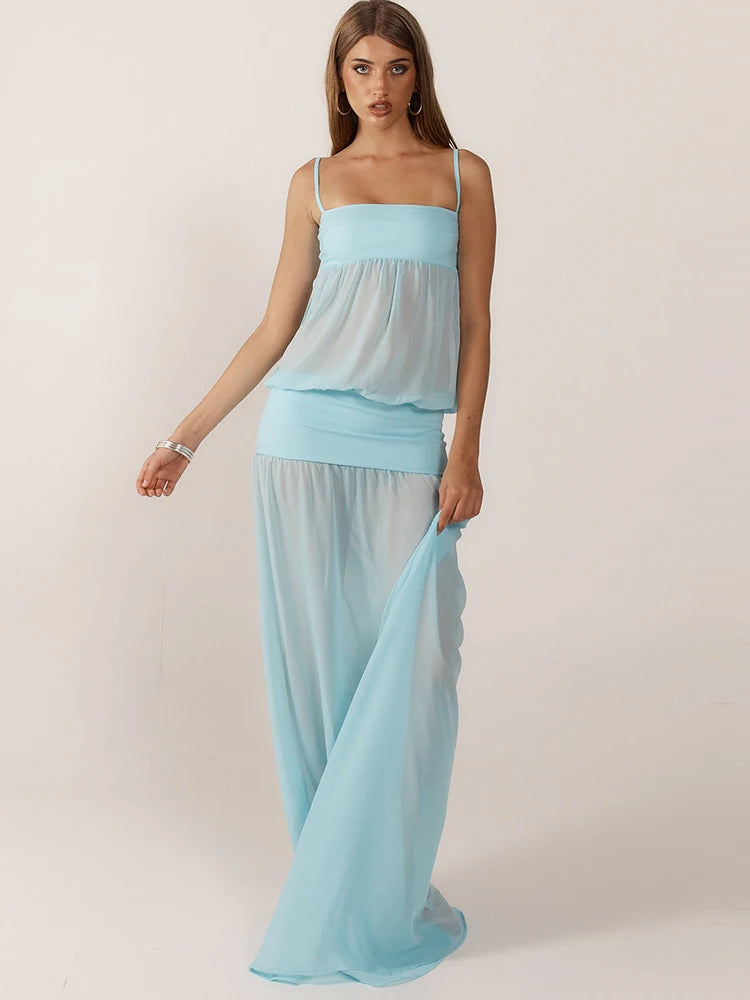 Woman wearing a light blue dress against a plain background