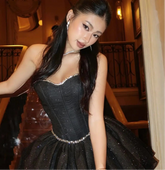 Woman in a black dress  in an elegant interior setting