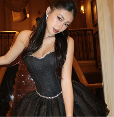 Woman in a black dress in an elegant interior setting