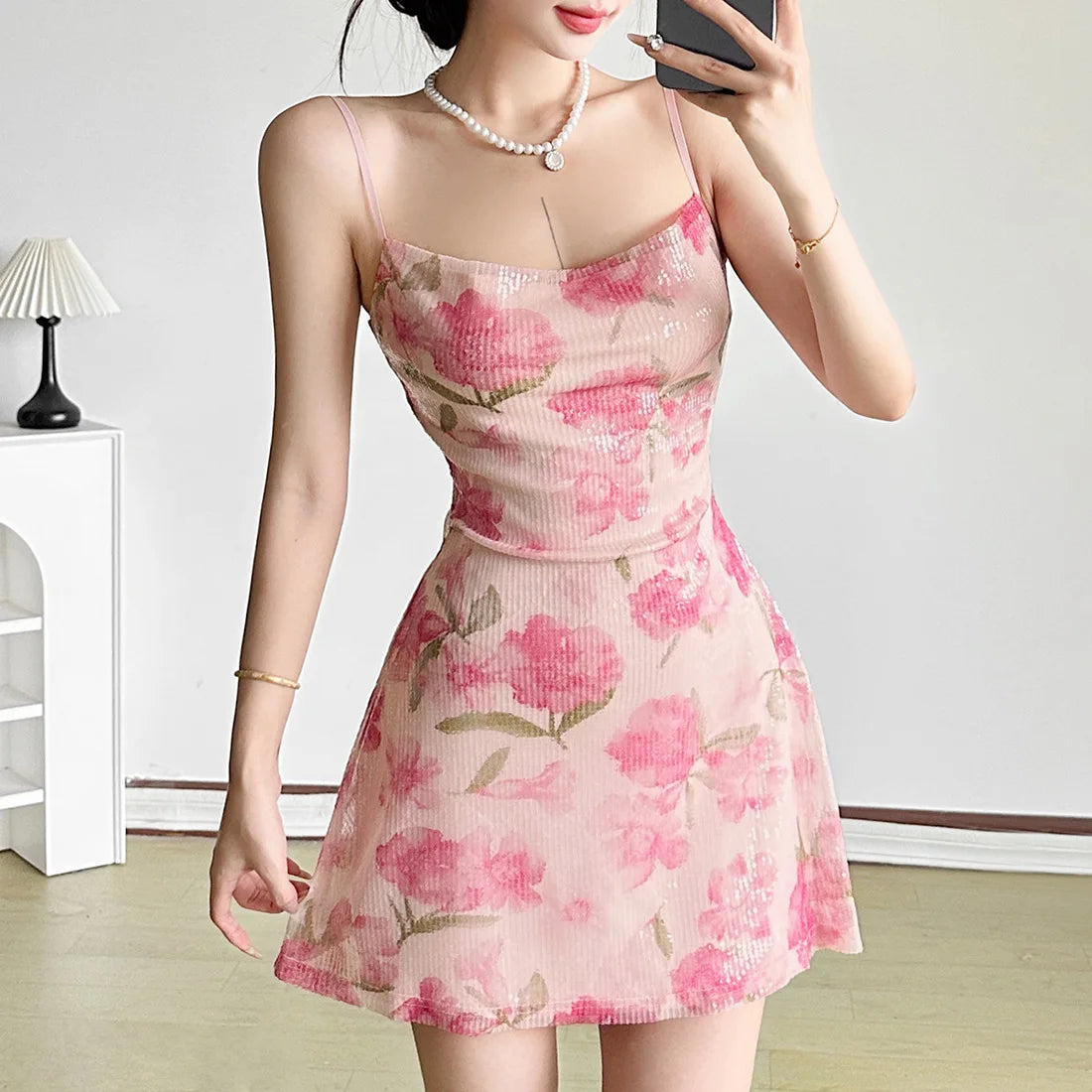 Woman wearing a pink floral dress in an indoor setting
