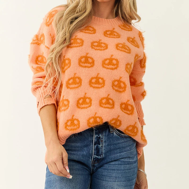 Person wearing an orange sweater with pumpkin patterns