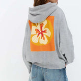 Gray hoodie with a colorful flower design on the back