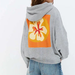 Gray hoodie with a colorful flower design on the back