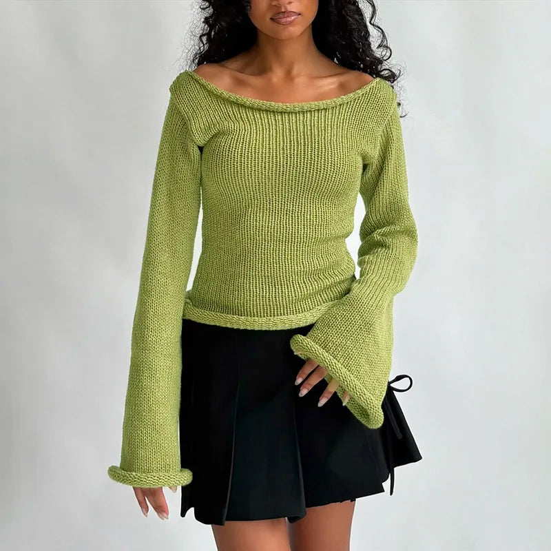 Woman wearing a green knitted sweater and black skirt
