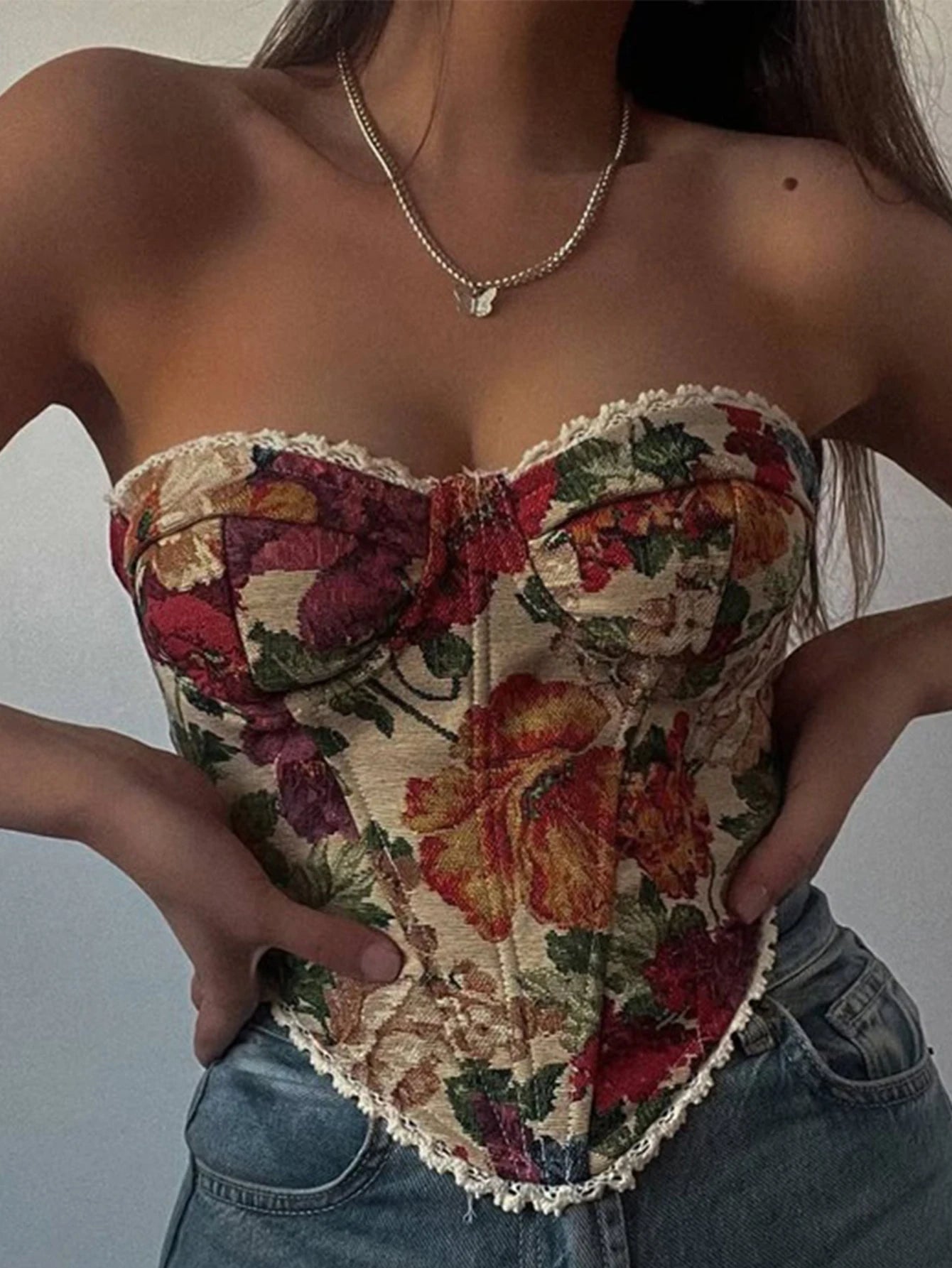 Floral corset worn over a plain background