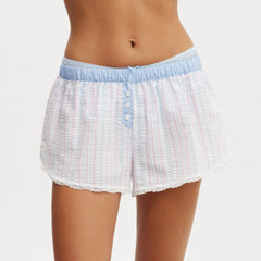 White textured shorts with blue waistband and buttons on a white background