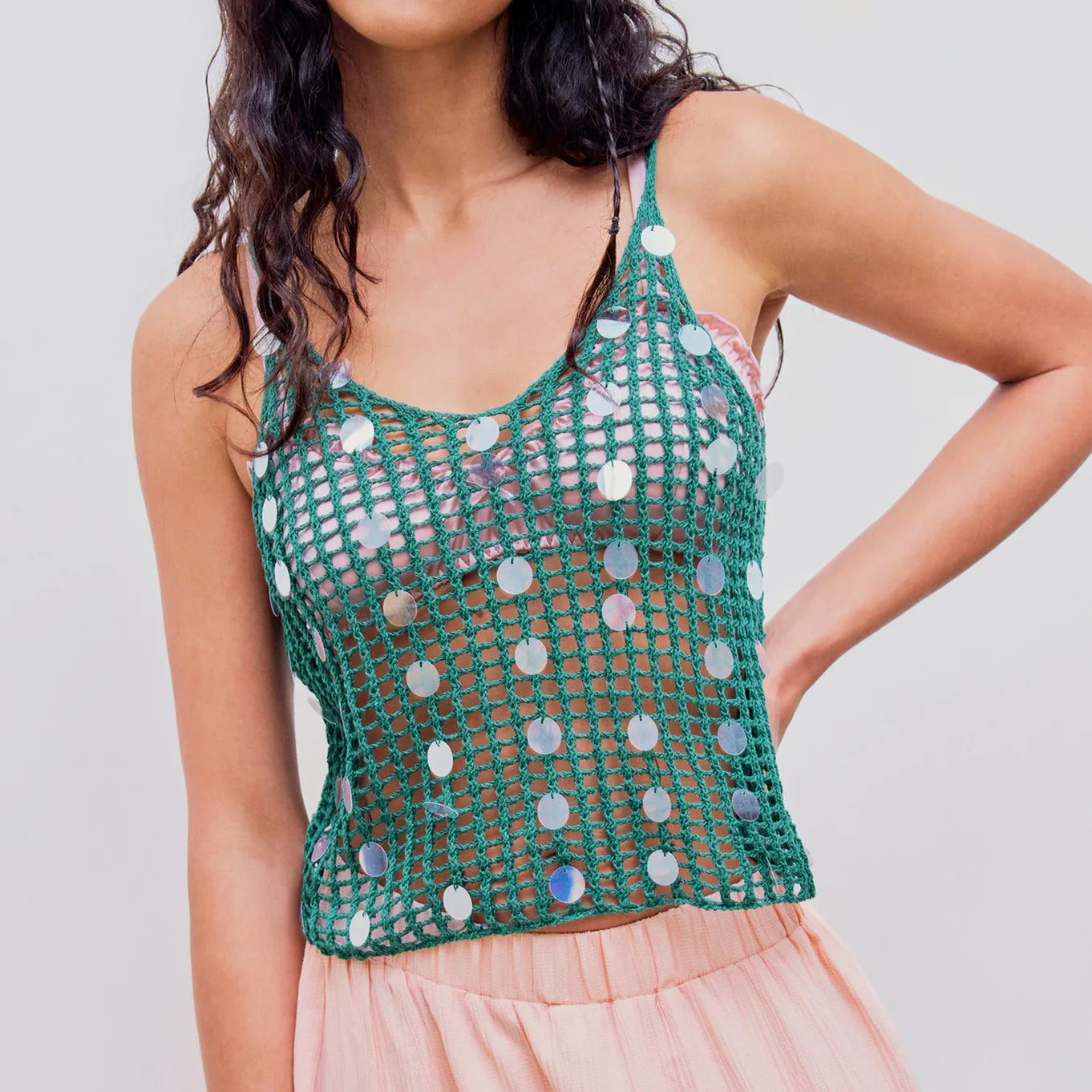 Women's green knit sequin tank top with a short length.