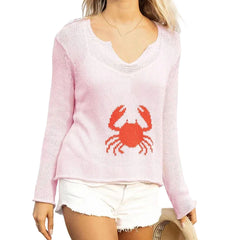 Pink sweater with a red crab design worn by a person